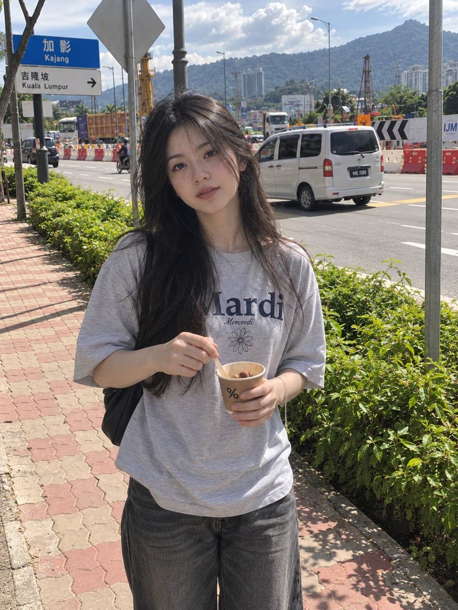 Candid smartphone photo of woman holding coffee outdoors